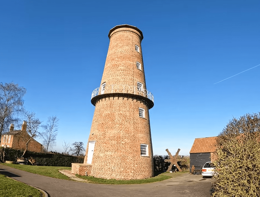 Sibsey Trader Windmill brick tower windmill with circular balcony and surrounding countryside in Lincolnshire.