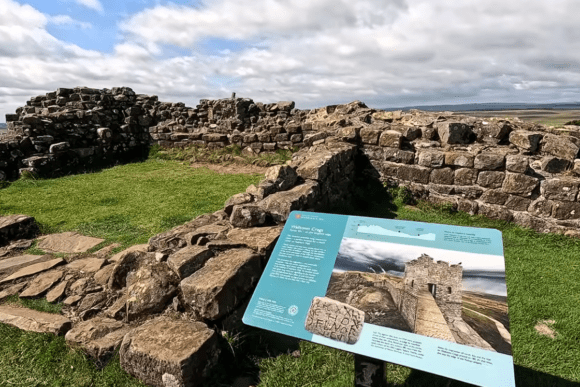 Ancient stone ruins at Walltown Crags along Hadrian’s Wall in Northumberland, featuring historic Roman fortifications, green grassland, and panoramic countryside views.