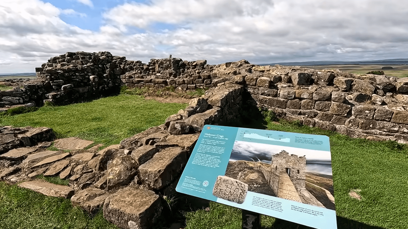 Ancient stone ruins at Walltown Crags along Hadrian’s Wall in Northumberland, featuring historic Roman fortifications, green grassland, and panoramic countryside views.